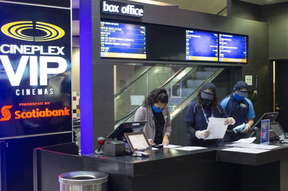 Cineplex employees work at a Cineplex in Toronto, on Tuesday, Oct. 6, 2020. THE CANADIAN PRESS/Chris Young