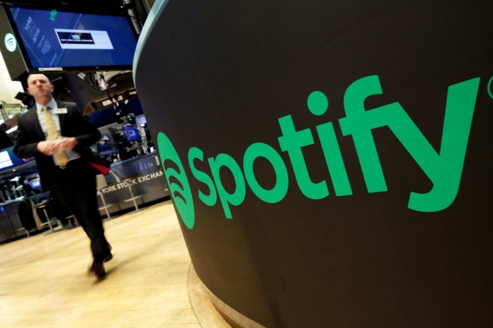 FILE - A trading post sports the Spotify logo on the floor of the New York Stock Exchange, Tuesday, April 3, 2018. (AP Photo/Richard Drew, File)