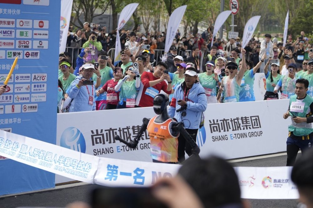 Sky Project Ultra robot crosses the finish line to win the world's first robot half marathon during the Humanoid Robot Half-Marathon held in Beijing on Saturday, April 19, 2025. (AP Photo/Ng Han Guan)