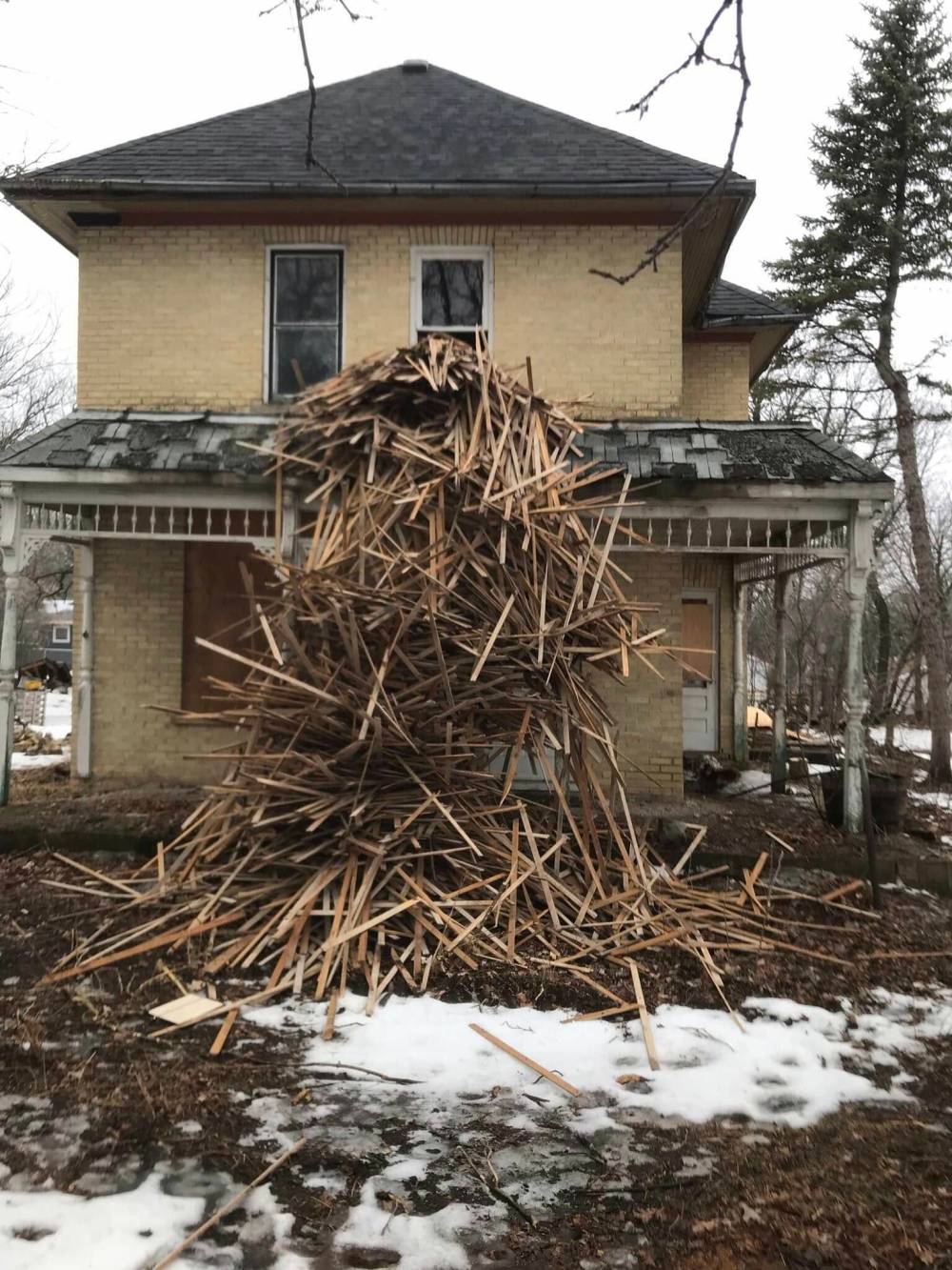 A pile of lath is seen in the front yard of Friesen’s abandoned home in the winter of 2023-24. The scraps were thrown out of the window as the interior of the house was gutted. (Neil Friesen)