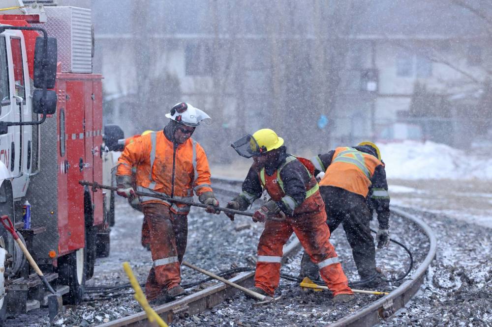 A Canadian National Railway crew on Tuesday conducts repairs to a section of track just off Sixth Street close to where a train derailed on Monday afternoon. (Matt Goerzen/The Brandon Sun)