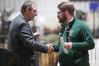 Agriculture Minister Ron Kostyshyn shakes hands with Manitoba 4-H Council president Greg Penner after Tuesday’s cheque presentation on 4-H Day at the Royal Manitoba Winter Fair. (Connor McDowell/The Brandon Sun)