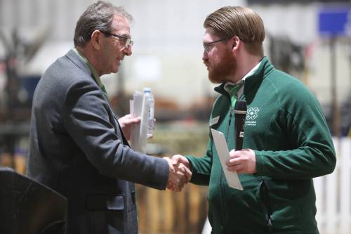 Agriculture Minister Ron Kostyshyn shakes hands with Manitoba 4-H Council president Greg Penner after Tuesday&rsquo;s cheque presentation on 4-H Day at the Royal Manitoba Winter Fair. (Connor McDowell/The Brandon Sun)