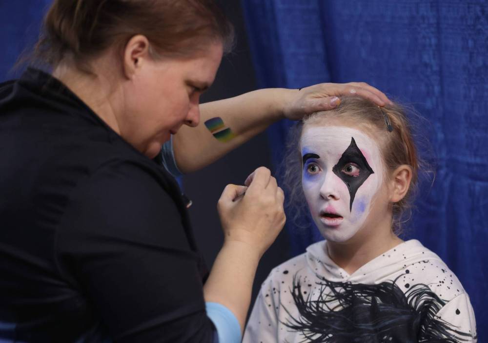 A young girl named Alyson from Stonewall, MB opens her eyes wide while getting her face painted at the Royal Manitoba Winter Fair on Monday afternoon.