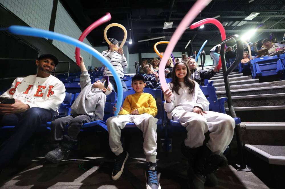 Pascha, 11, Isshan, 7, and four-year-old Zayn wave balloons in the air as they wait for Doodles the Clown in the Keystone Centre amphitheatre on Monday afternoon during the Royal Manitoba Winter Fair.
