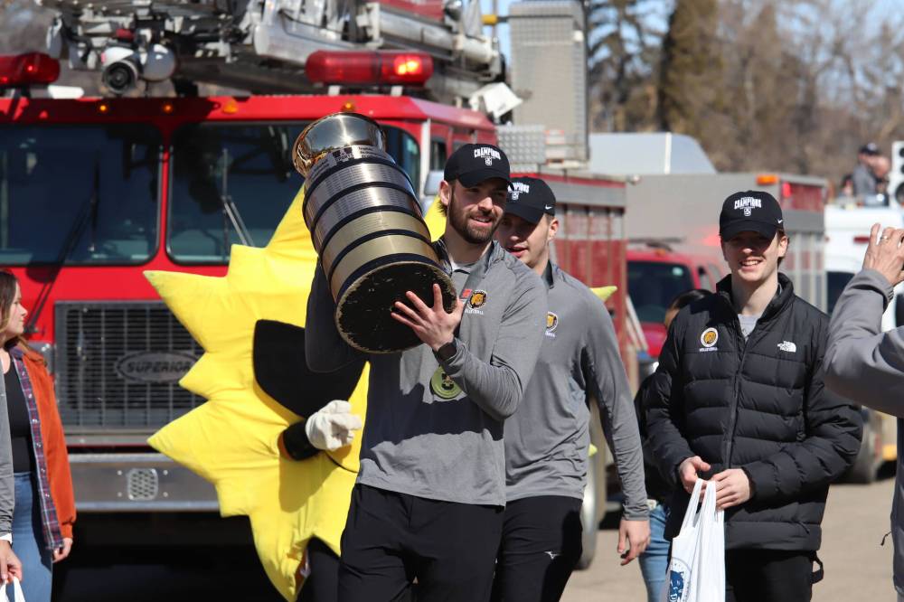Brandon University Bobcats captain JJ Love carries the U Sports men’s volleyball trophy during the team’s championship parade on 20th Street outside the Healthy Living Centre on Friday. The team was escorted by members of Brandon Fire and Emergency Services and Brandon Police Service from Firehall No. 1. (Liam Pattison/The Brandon Sun)