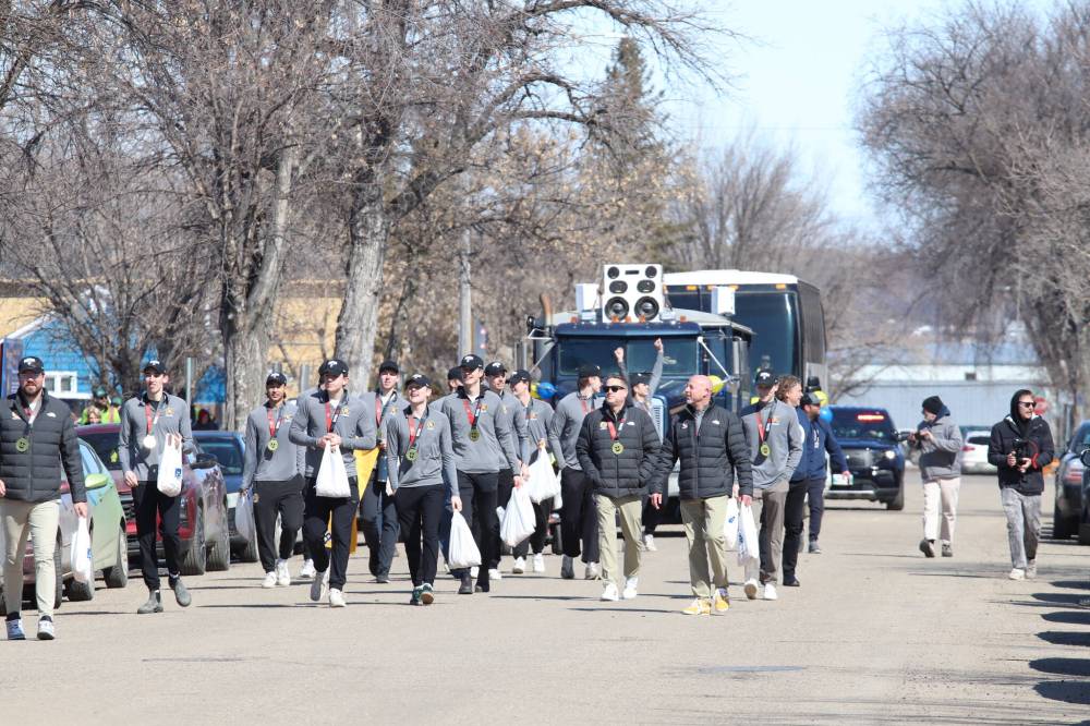 The Brandon University Bobcats walk in the victory parade in Brandon Friday to celebrate their recent U Sports national men’s volleyball championship. (Liam Pattison/The Brandon Sun)