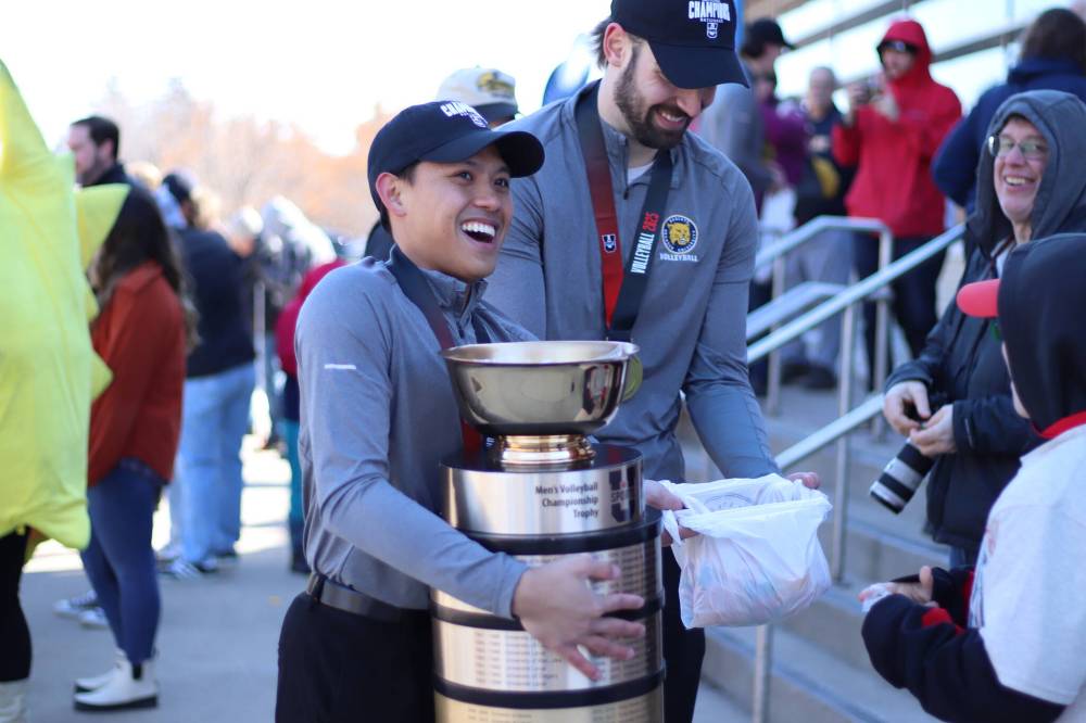 Bobcats captains Michael Flor (left) and JJ Love hand out candy to fans at Friday’s parade. (Liam Pattison/The Brandon Sun)