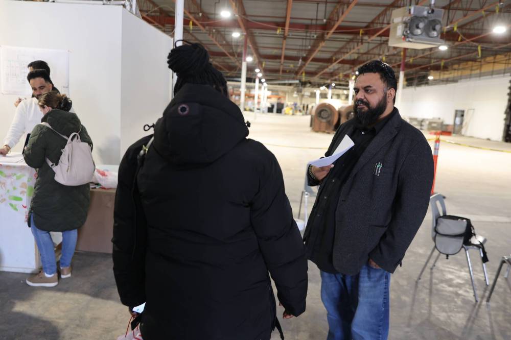 Connecting Dots Foundation operations director Navroop Ghumman answers questions from a Brandon parent about the proposed plan for the child-care facility during an open house on Saturday afternoon. (Abiola Odutola/The Brandon Sun)
