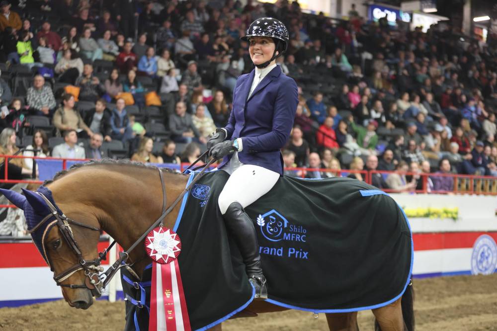 Kate Curry and her horse, Irvine, are shown following their victory in the Grand Prix show jumping finale on Saturday evening at the Royal Manitoba Winter Fair. (Photos by Abiola Odutola/The Brandon Sun)