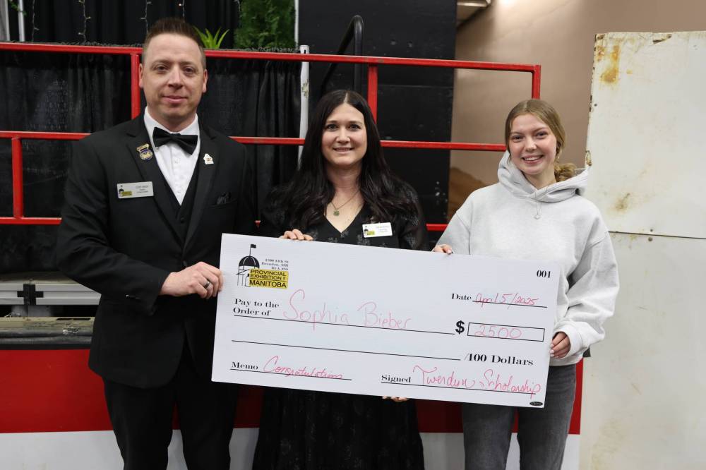 Provincial Exhibition president Clint Swain and executive director Candace Bowles present a scholarship cheque to young rider Sophie Bieber (right).