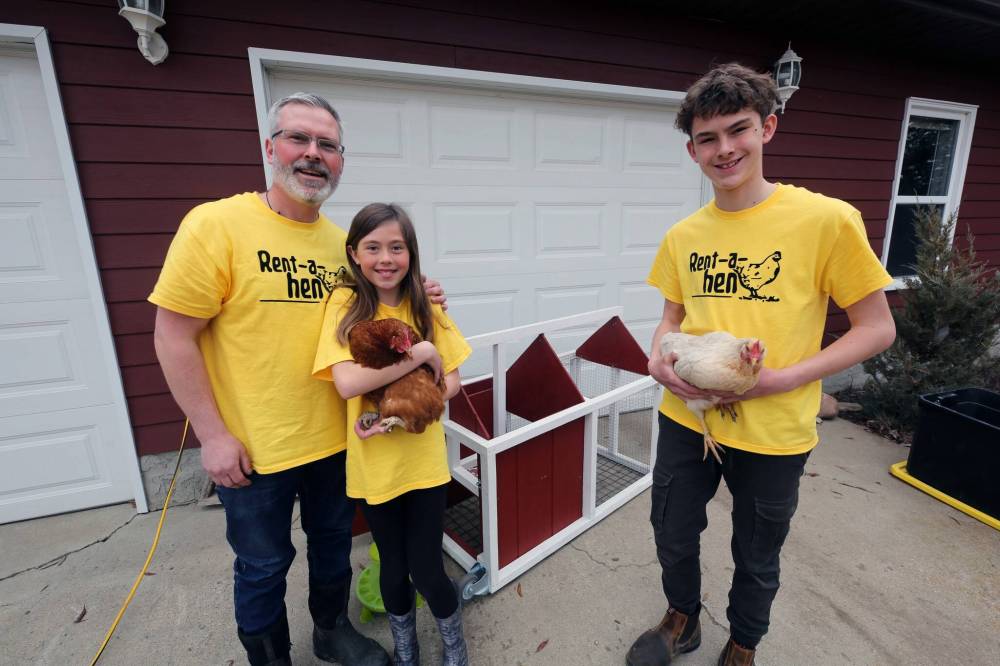 David Long, his children Marlee and Nolan, and wife Robyn (not pictured) are launching a business to deliver egg-laying hens and a chicken coop to doorsteps in Westman. The family is seen with two chickens, Rosemary and Harriet, along with a coop they built for a customer that will go in a backyard this May. (Photos by Connor McDowell/The Brandon Sun)