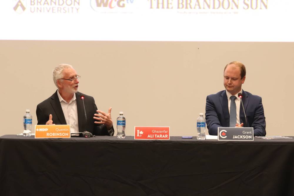 Brandon-Souris NDP candidate Quentin Robinson (left) makes a point while Conservative candidate Grant Jackson listens during the all-candidates’ debate at Brandon University on Wednesday. A place was kept for Liberal candidate Ghazanfar Ali Tarar, but he did not attend, citing a family medical emergency. (Liam Pattison/The Brandon Sun)