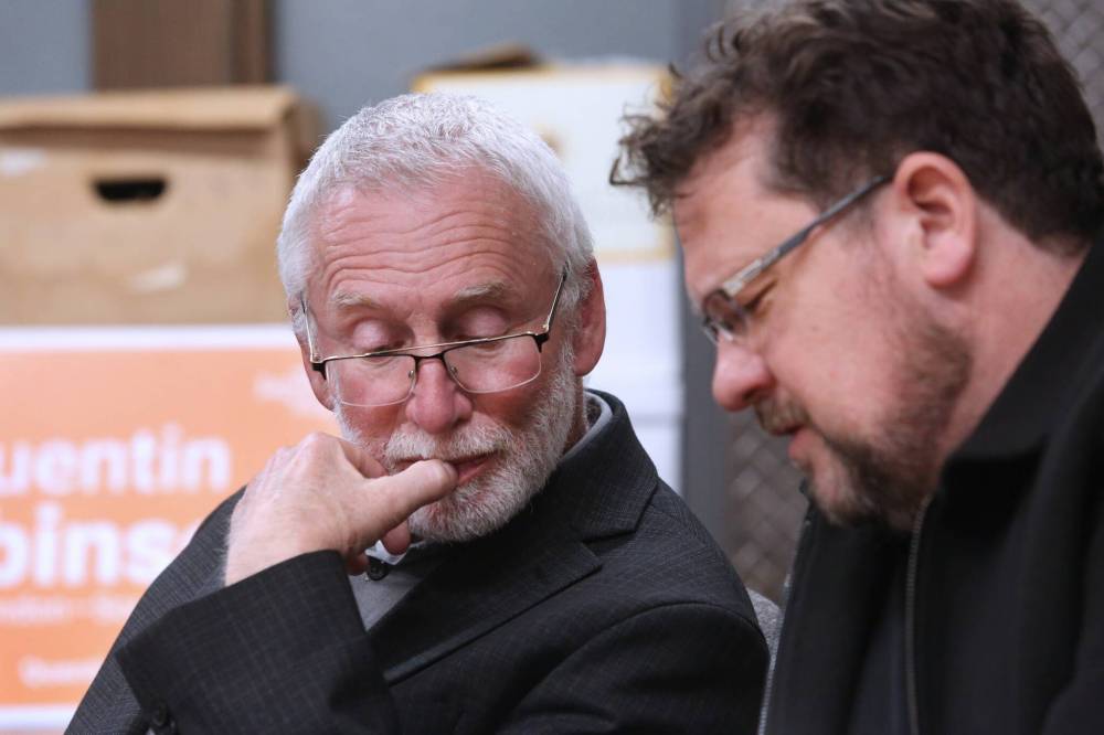 Brandon-Souris federal NDP candidate Quentin Robinson watches poll results with Glen Simard, Brandon East NDP MLA and Manitoba’s minister of municipal and northern relations, on Monday night at the Brandon and District Labour Council office on Rosser Avenue. (Matt Goerzen/The Brandon Sun)