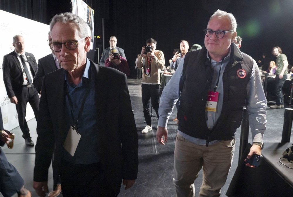 Ezra Levant, right, of Rebel News is escorted from the press room by Michel Cormier, left, the executive director of the Leaders' Debates Commission prior to the English language leaders debate in Montreal on Thursday, April 17, 2025. THE CANADIAN PRESS/Peter McCabe