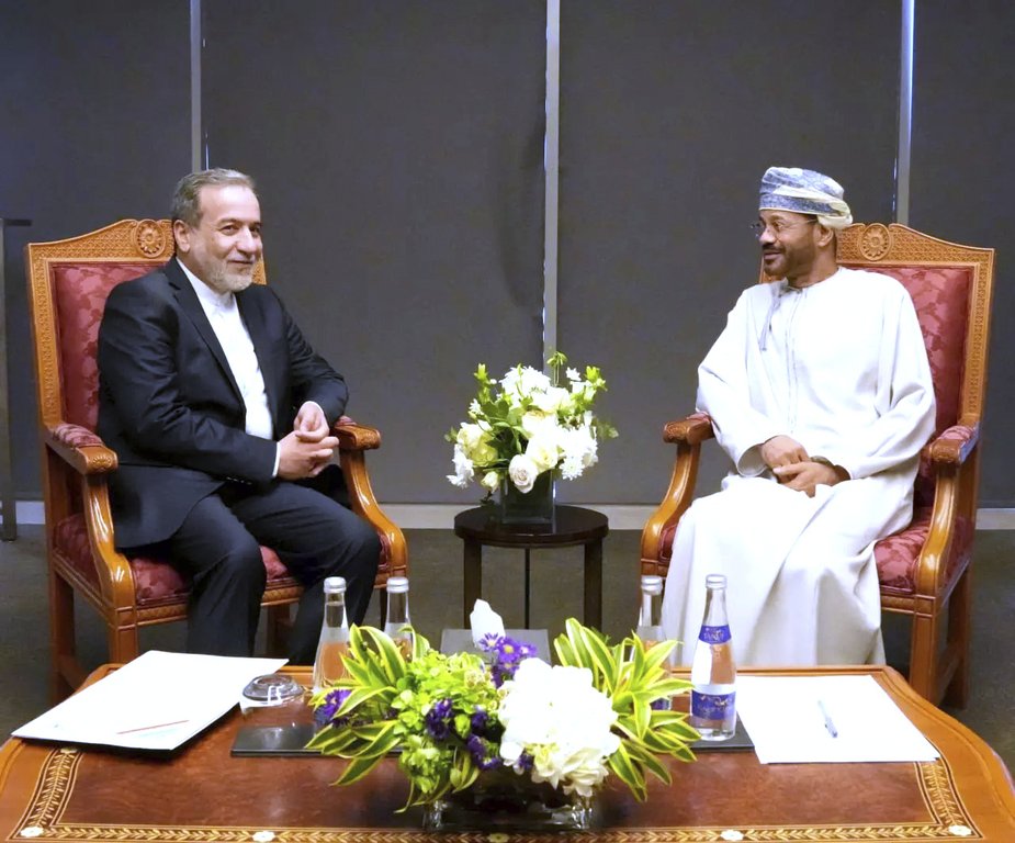 In this photo released by Iranian Foreign Ministry, Iranian Foreign Minister Abbas Araghchi, left, meets his Omani counterpart Sayyid Badr Albusaidi prior to negotiations with U.S. Mideast envoy Steve Witkoff in Muscat, Oman, Saturday, April 12, 2025. (Iranian Foreign Ministry via AP)