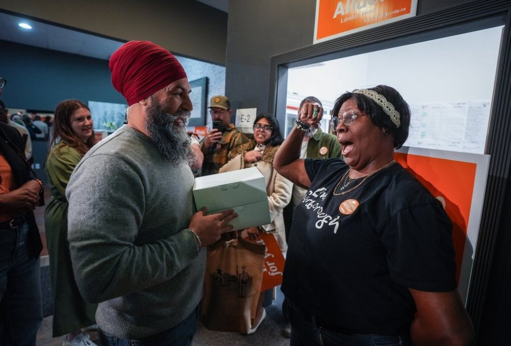 NDP Leader Jagmeet Singh speaks with a supporter while delivering baked goods and chocolates to volunteers at the London Centre and London West NDP campaign office, in Windsor, Ont., Saturday, April 26, 2025. THE CANADIAN PRESS/Darryl Dyck