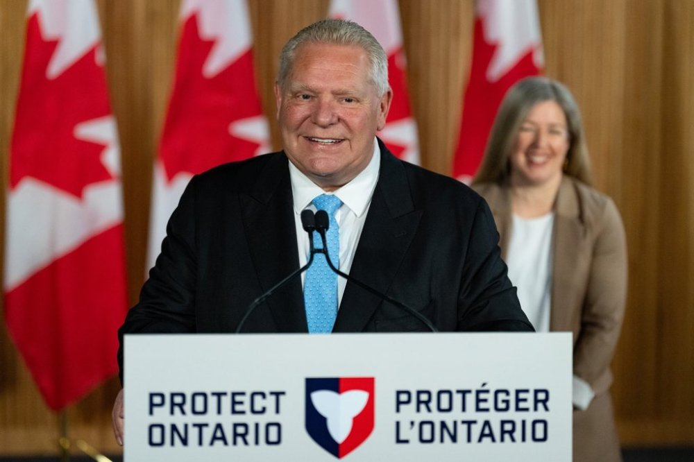 Ontario Premier Doug Ford speaks as New Brunswick Premier Susan Holt looks on, at a press conference in Toronto on Wednesday, April 16, 2025. THE CANADIAN PRESS/Arlyn McAdorey