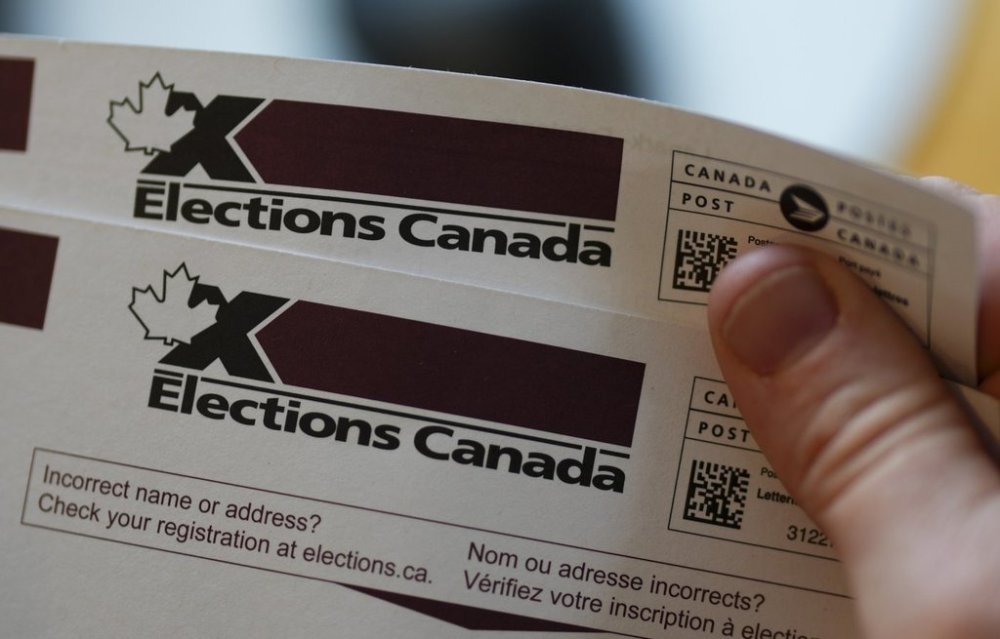 An eligible voter holds a voter information card after it arrived in the mail in Carleton Place, Ont., Friday, April 11, 2025. THE CANADIAN PRESS/Sean Kilpatrick
