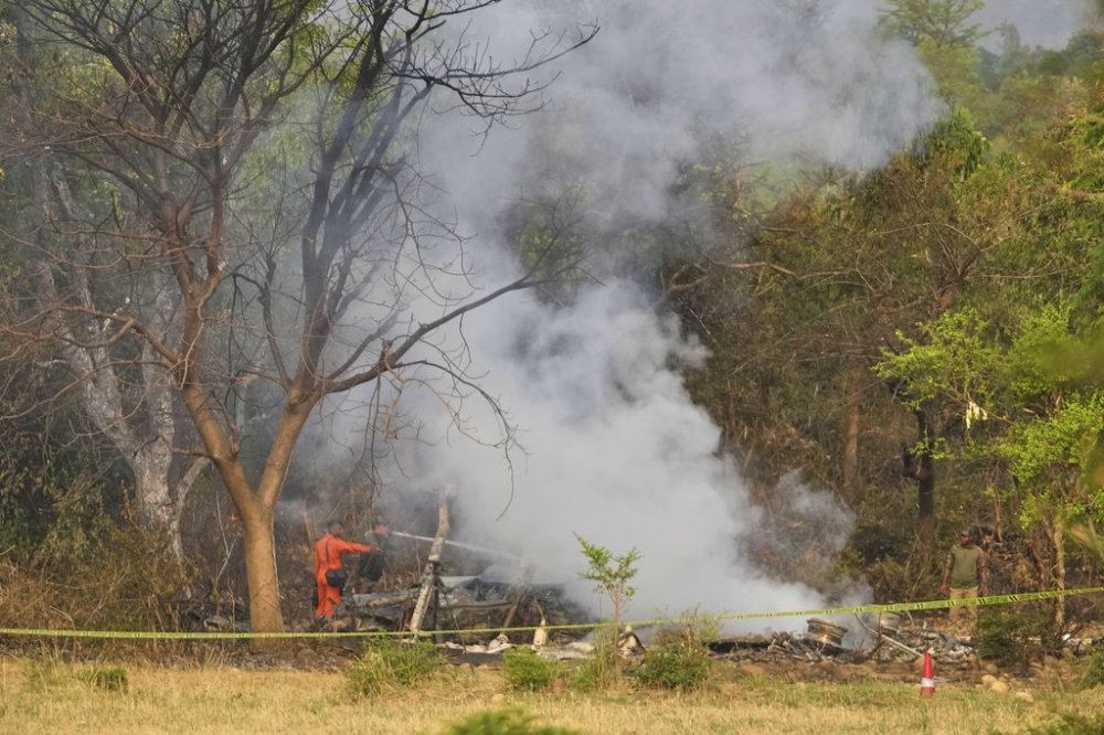 Fire fighters douse smoke coming out from the debris of an aircraft near Akhnoor on the outskirts of Jammu, India, Wednesday, May 7, 2025. (AP Photo/Channi Anand)