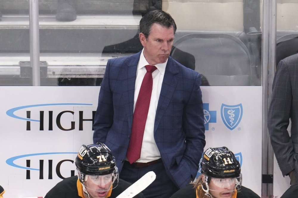 Pittsburgh Penguins head coach Mike Sullivan stands behind his bench during the third period of an NHL hockey game against the Boston Bruins in Pittsburgh, Sunday, April 13, 2025. (AP Photo/Gene J. Puskar)