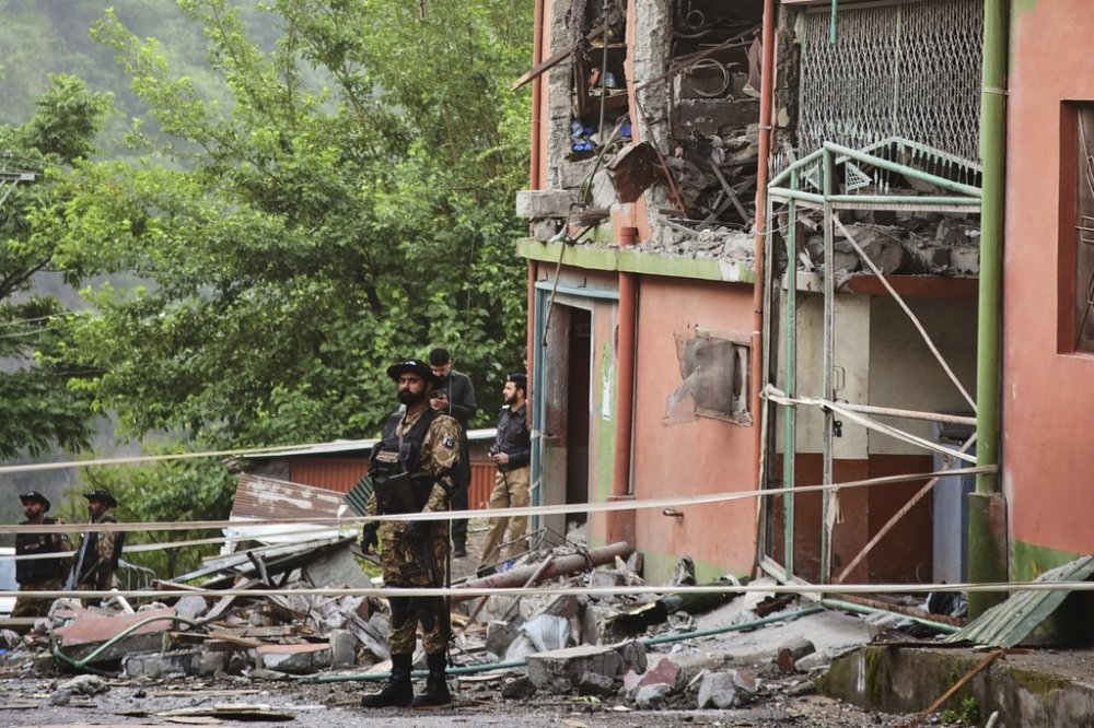 Army soldiers stand guard at a mosque building damaged by a suspected Indian missile attack near Muzaffarabad, the capital of Pakistan controlled Kashmir, on Wednesday, May 7, 2025. (AP Photo/M.D. Mughal)