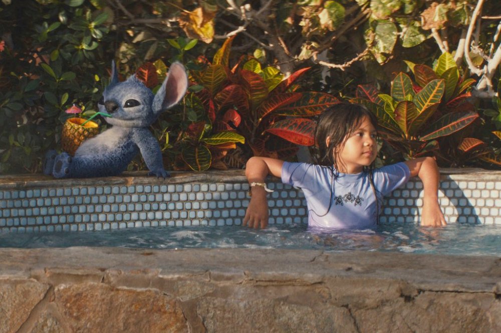 This image released by Disney shows the character Stitch, left, and Maia Kealoha, as Lilo, in a scene from