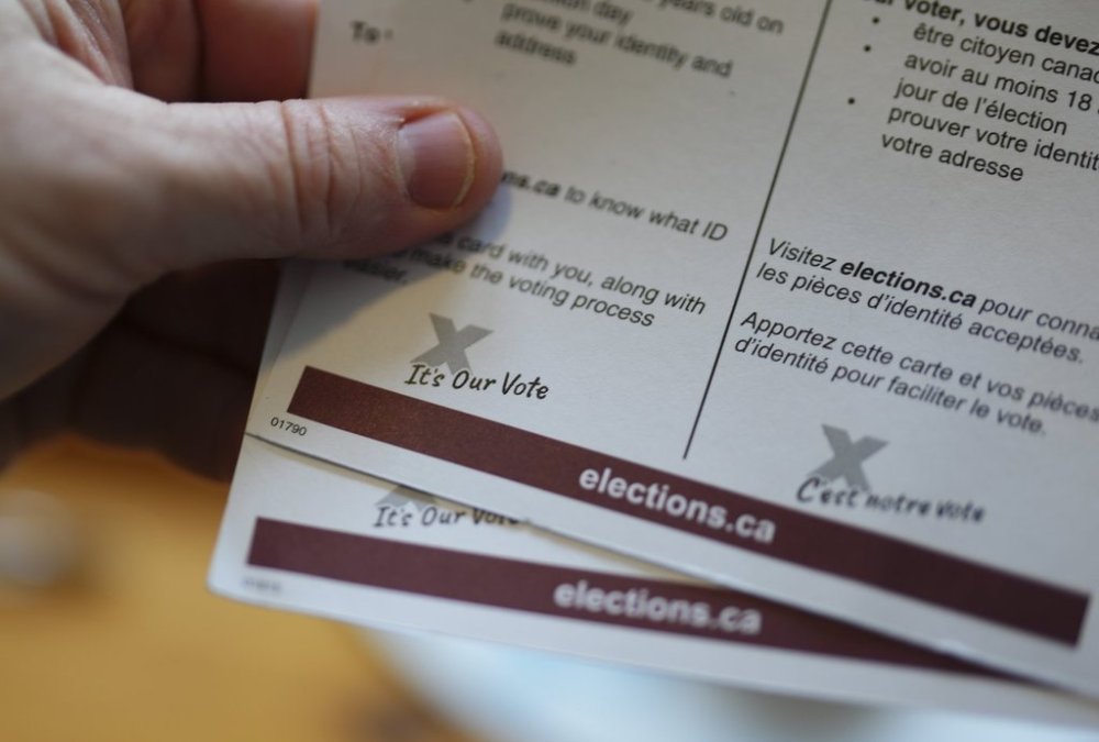 A eligible voter holds a voter information card that arrived in the mail in Carleton Place, Ont., Friday, April 11, 2025. THE CANADIAN PRESS/Sean Kilpatrick