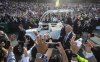 People gather to get a closer look as Pope Francis arrives for mass in Edmonton during his visit to Canada on Tuesday, July 26, 2022. THE CANADIAN PRESS/Jason Franson.