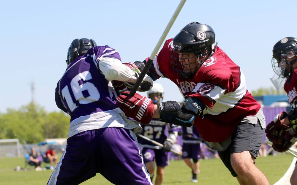 Vincent Massey’s Jude Falkevitch (16) takes a hit during the second quarter. (Thomas Friesen/The Brandon Sun)