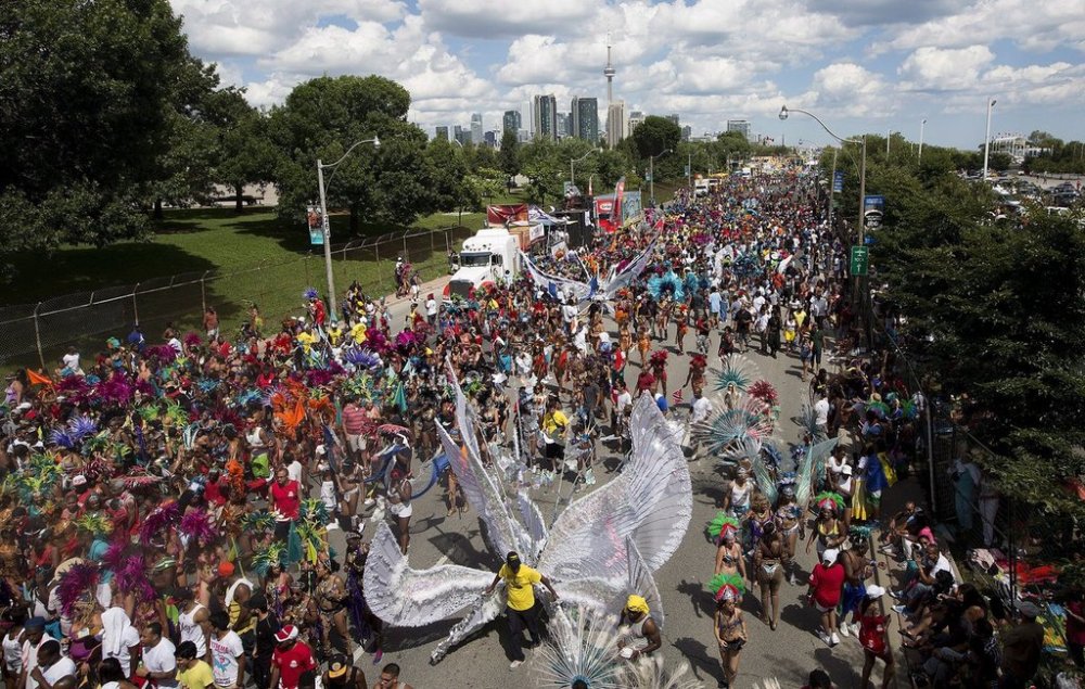 Paraders march down Lakeshore Boulevard at the Caribbean Carnival in Toronto on Saturday, August 3, 2013. THE CANADIAN PRESS/Michelle Siu