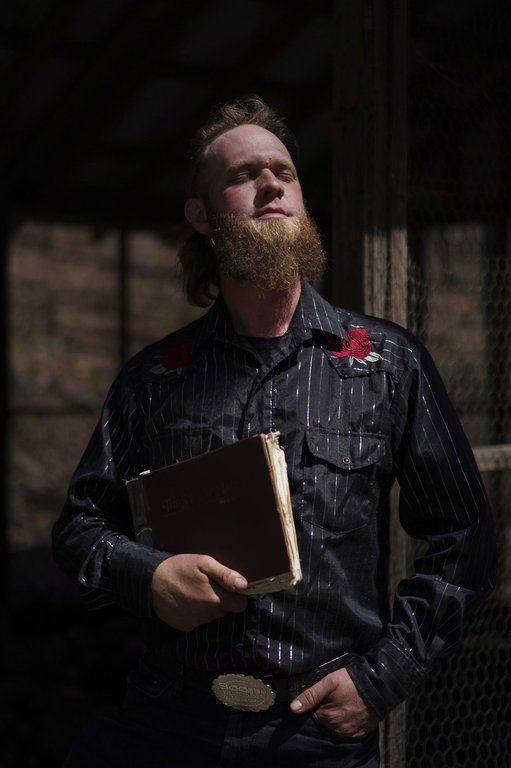 Isaac Green, 34, poses for a portrait with his copy of