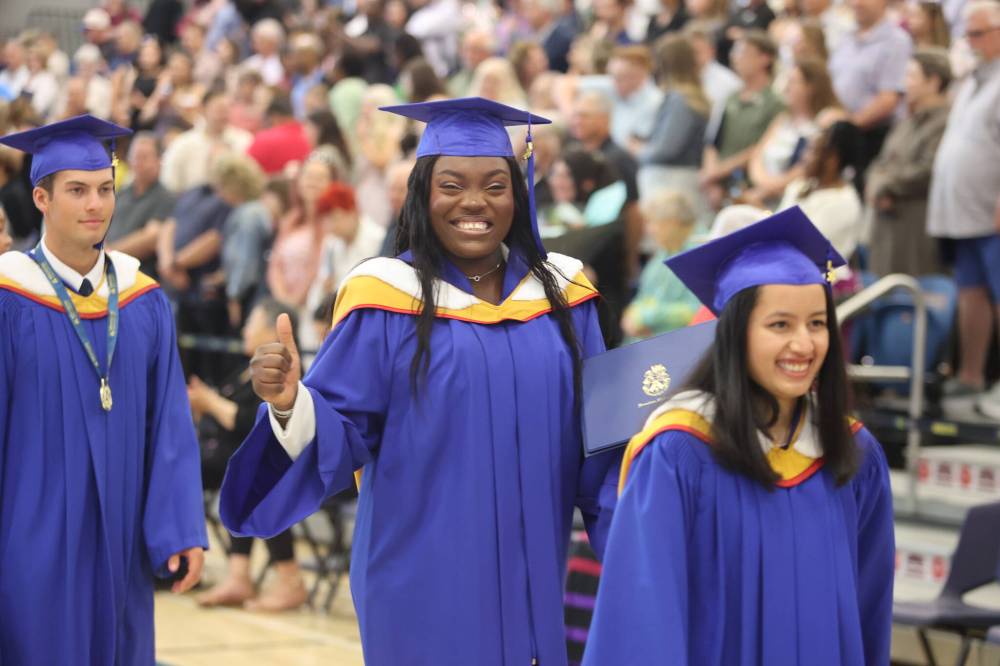 Bachelor of business administration (honours) graduate Tolulope Oke (second from right) shows excitement as she files out of the BU Healthy Living Centre on Friday afternoon after the convocation ceremony. (Photos by Abiola Odutola/The Brandon Sun)