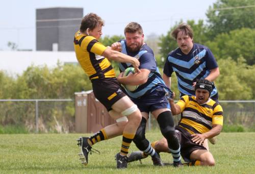 Brandon Barbarians Adam Kowalchuk runs over a Winnipeg Wasp during their Rugby Manitoba men's Division 2 game on Saturday. (Thomas Friesen/The Brandon Sun)
