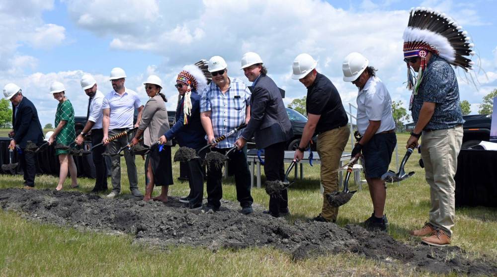 Organizers and community members shovel dirt at the sod-turning ceremony at the site of the new Gambler First Nation hotel in Brandon on Tuesday. (Alex Lambert/The Brandon Sun)