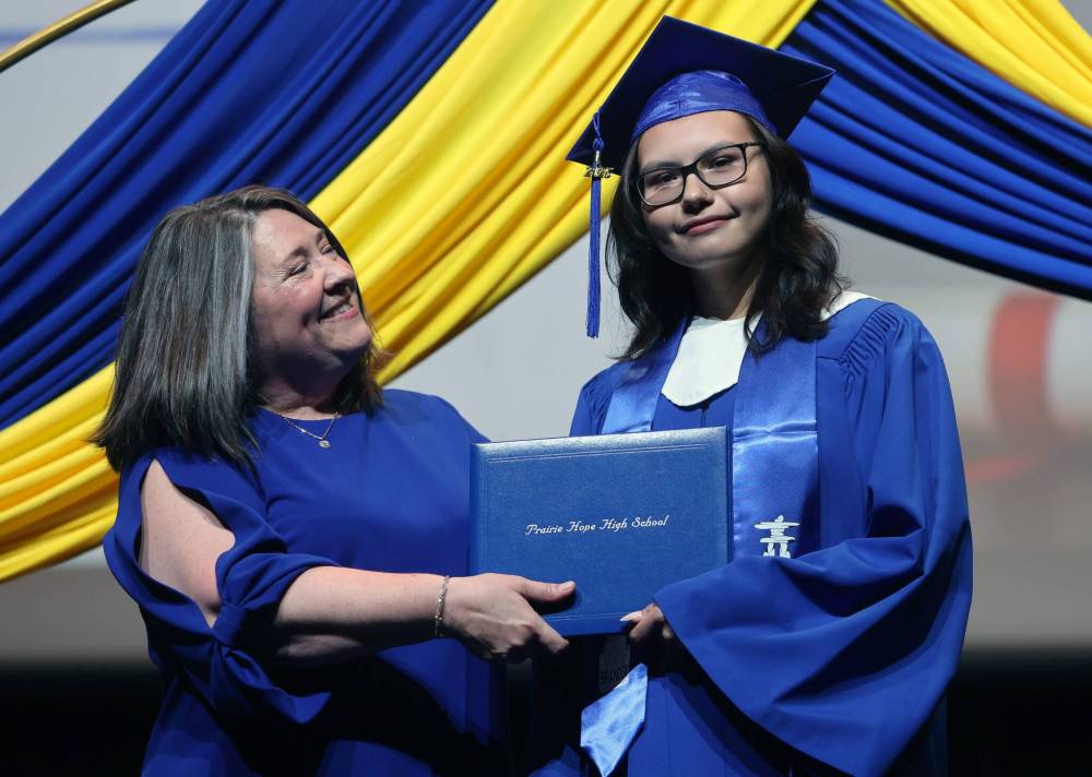 Prairie Hope High School graduate Rhythme Fagnan-Peters (right) receives her diploma from Principal Katherine MacFarlane. (Alex Lambert/The Brandon Sun)