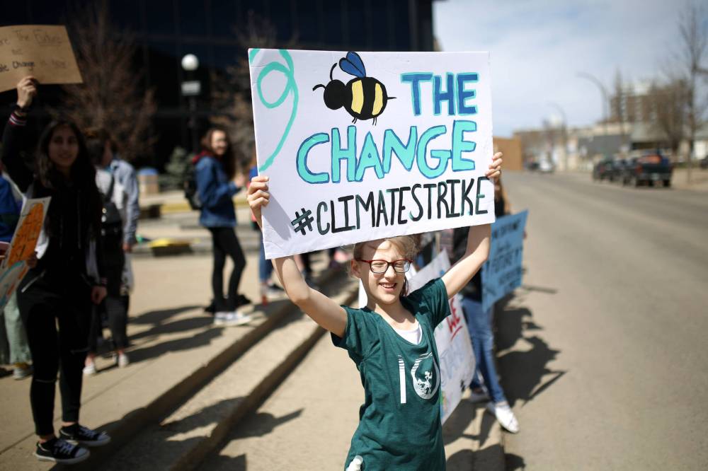 In this 2019 file photo, Grade 6 École New Era School student Haylee Harrison holds a placard while joining students from École Secondaire Neelin High School in a climate strike protest organized by the Neelin Eco Club in front of Brandon City Hall. A new study suggests teachers want to do a better job at teaching about climate change, and students want to learn, but they’re not getting much support. (Tim Smith/The Brandon Sun files)