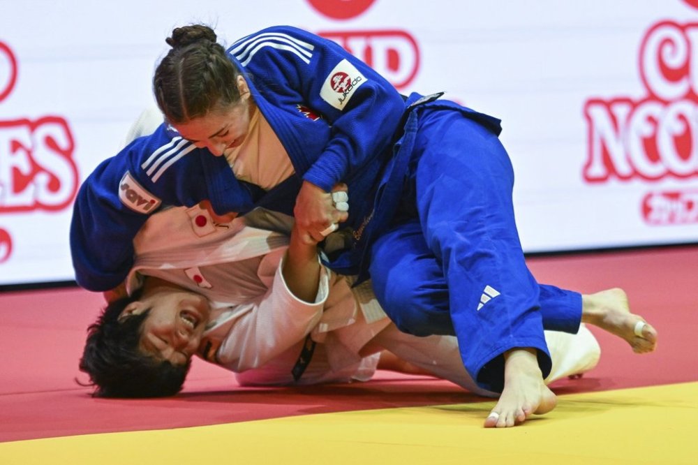 Japan's Haruka Kaju, left, and Canada's Catherine Beauchemin-Pinard fight in the final of women's -63kg category of the World Judo Championships in Papp Laszlo Budapest Sports Arena in Budapest, Hungary, Monday, June 16, 2025. (Tibor Illyes/MTI via AP)