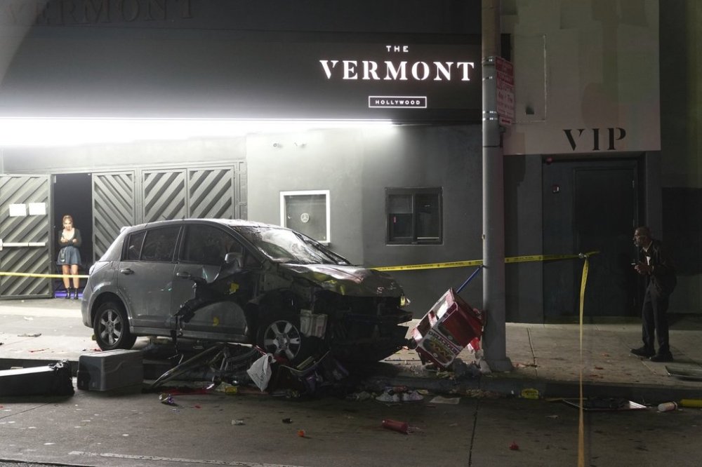 A vehicle sits on the sidewalk after ramming into a crowd of people waiting to enter a nightclub along a busy boulevard in Los Angeles early Saturday, July 19, 2025 injuring several people. (AP Photo/Damian Dovarganes)