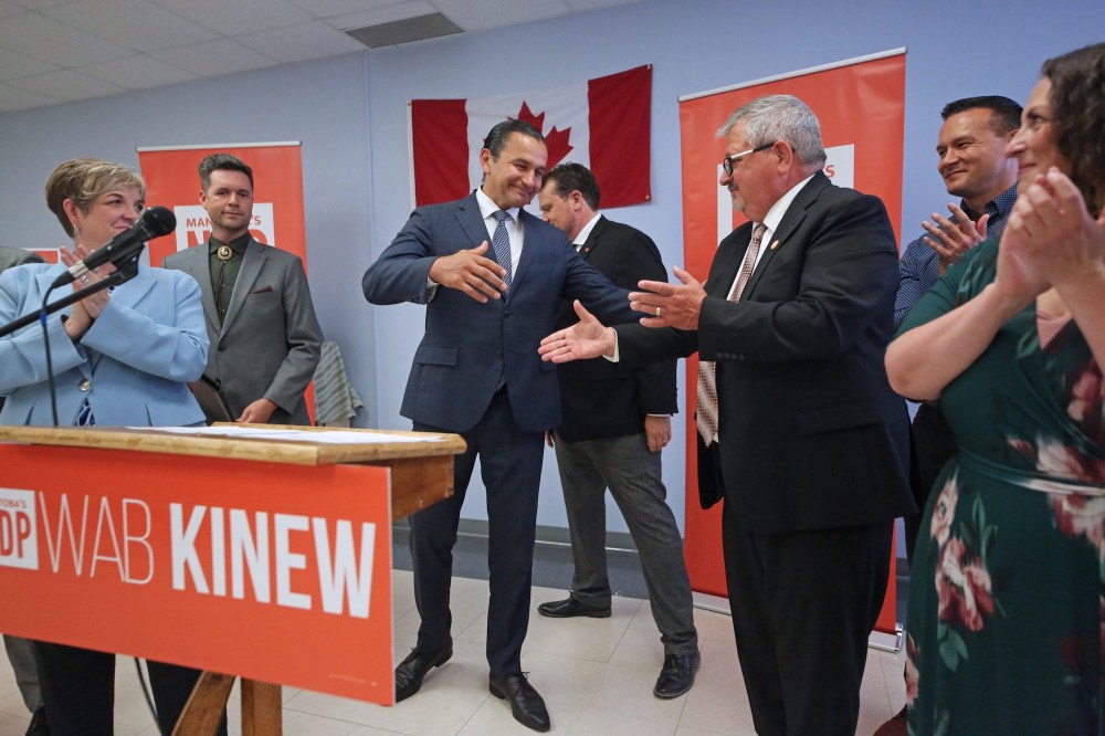 Manitoba Premier Wab Kinew prepares to shake the hand of newly minted NDP Spruce Woods candidate Ray Berthelette, who accepted his party's nomination on Thursday afternoon during a meeting on the North Hill. (Matt Goerzen/The Brandon Sun)