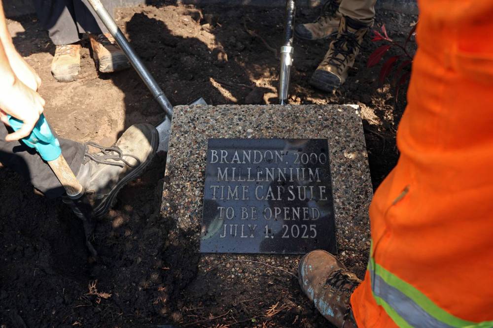City of Brandon workers dig up the Brandon 2000 Millennium Time Capsule, which was buried in a garden outside Brandon City Hall 25 years ago. The time capsule was created by the United Commercial Travelers (UCT) as part of Brandon City Council’s call-out for local organizations to create ways to celebrate the millennium. Brandon Mayor Jeff Fawcett opened the capsule and unveiled the contents to the crowd at city hall. (Tim Smith/The Brandon Sun)
