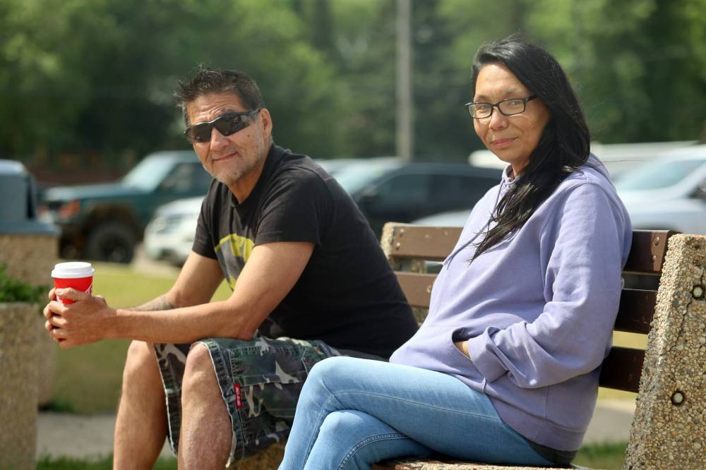 Split Lake evacuees Fred Cook and Genevieve Mayham sit outside their hotel in Brandon on Tuesday. The two were flown from their community at the start of June. (Alex Lambert/The Brandon Sun)