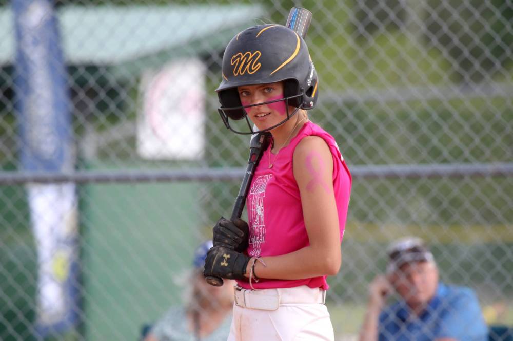 Meredith Masson watches for signals from coach Adam Hartman on Strike Out Cancer day in June. (Thomas Friesen/The Brandon Sun)