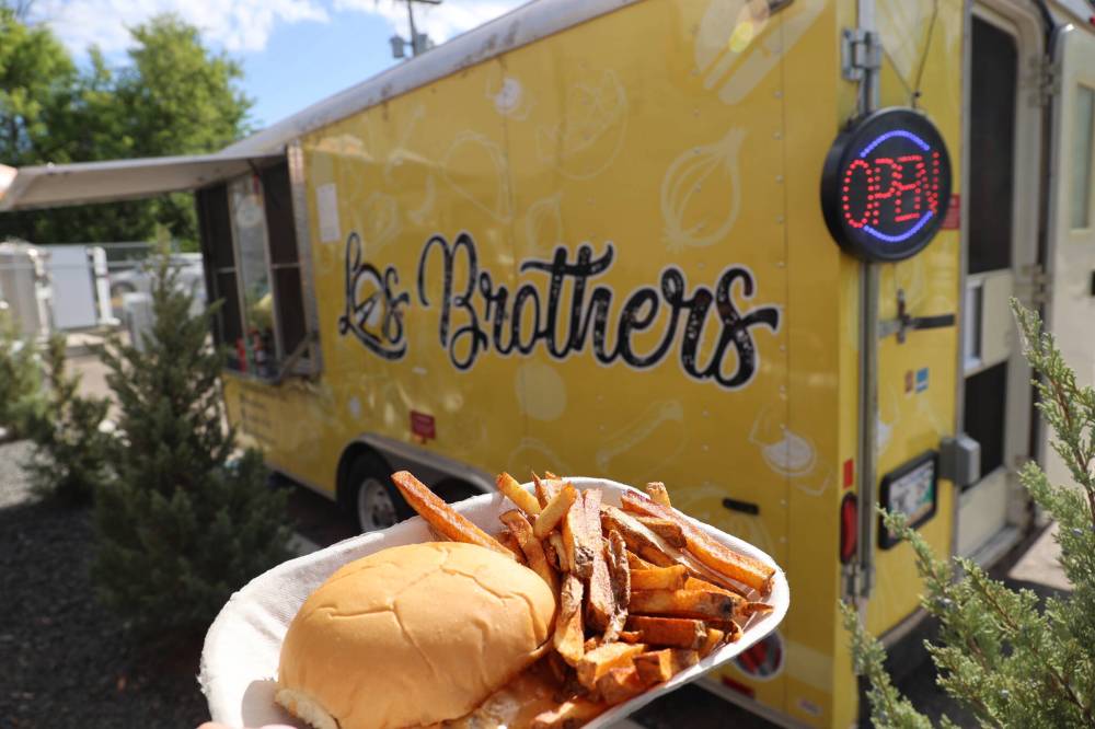 Los Brothers Street Food’s smash burger with fries is shown in front of the food truck on 10th Street in Brandon on Wednesday. (Photos by Skye Anderson/The Brandon Sun)