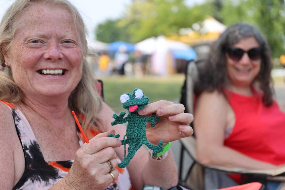 Marilyn Hardy holds a crocheted salamander puppet she made for the kids zone for this year’s Salamander Summer Music Festival.