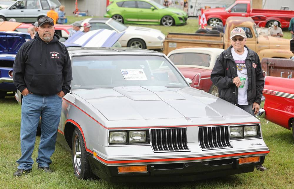 Jim De Vries (right) and his son Luke pose for a photo next to their 1984 Oldsmobile Hurst/Oldsmobile during a past Super Run event held in Brandon in 2022. (The Brandon Sun files)