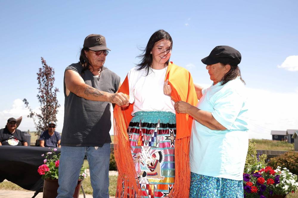 Grandparents Terry and Pauline Bell present Birdtail Sioux Dakota Nation Chief Tréchelle Bunn with a shawl during the swearing-in ceremony for the new chief and council at Birdtail on a hot Friday afternoon.