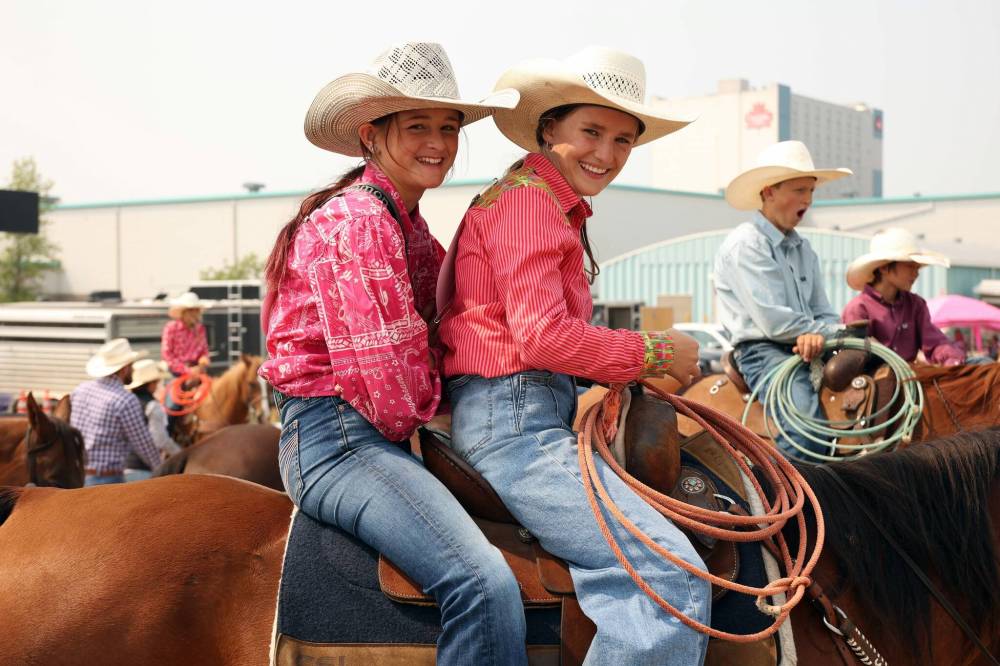 Johannah Logan and Presley Spencer sit together atop a horse between events at the 2025 Canadian High School Rodeo Finals at the Keystone Centre in Brandon on Thursday. (Tim Smith/The Brandon Sun)