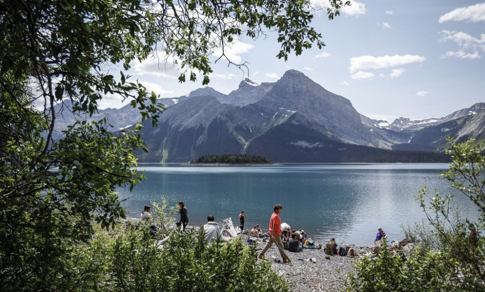 Participants take a lunch break beside Upper Kananaskis Lake while attending the Rockies Journey camp run by Howl in Kananaskis, Monday, July 3, 2023. THE CANADIAN PRESS/Jeff McIntosh