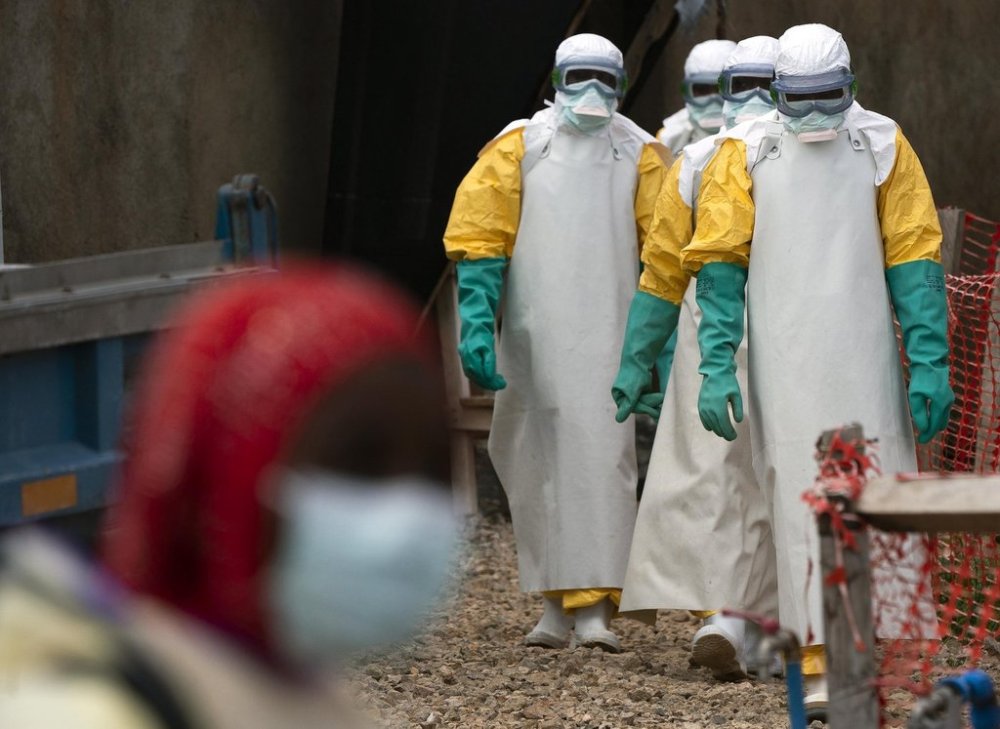 FILE - Health workers dressed in protective gear begin their shift at an Ebola treatment center in Beni, Congo DRC, Tuesday, July 16, 2019. (AP Photo/Jerome Delay, File)